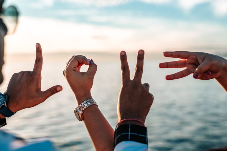 Hands with fingers spelling LOVE