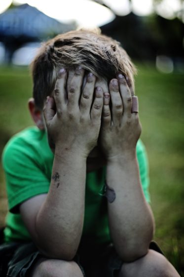 Child covering their face