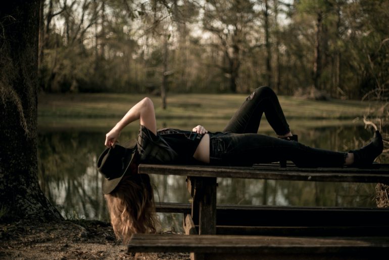 Girl laying on picnic table