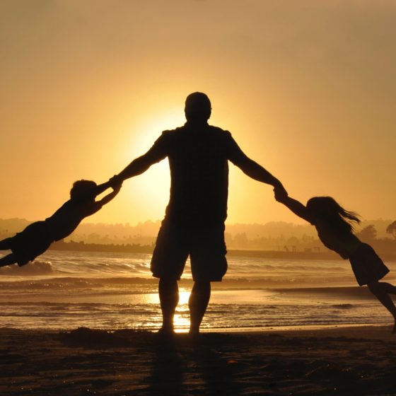 Father with children at sunset