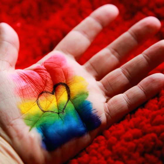 Rainbow and heart painted on a hand