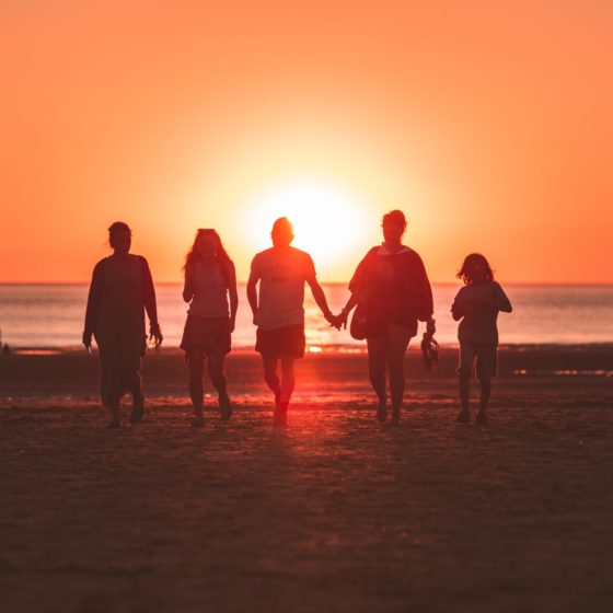 Family on the beach at sunset