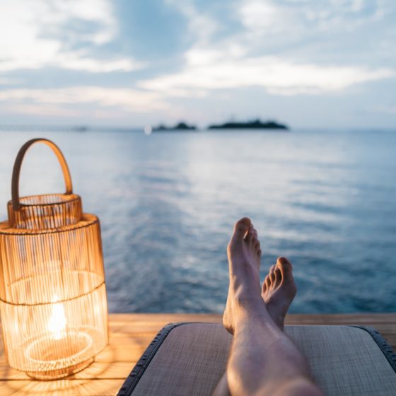 Person relaxing on lake dock