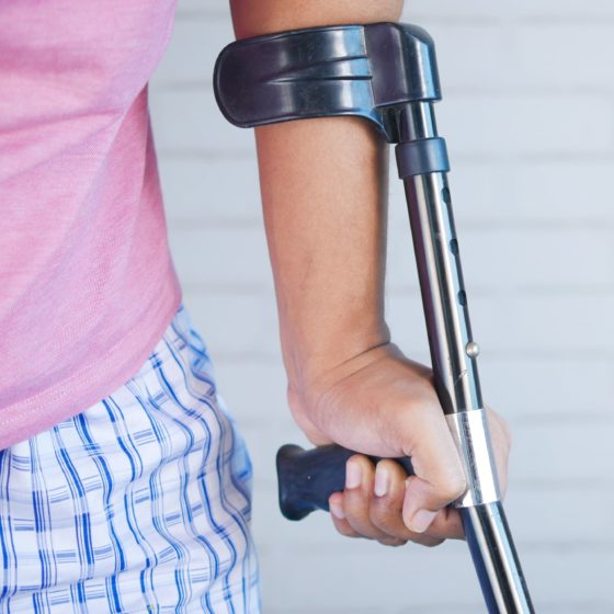 Close-up of arm with crutch