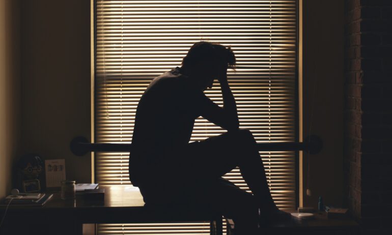Silhouette of a person worrying