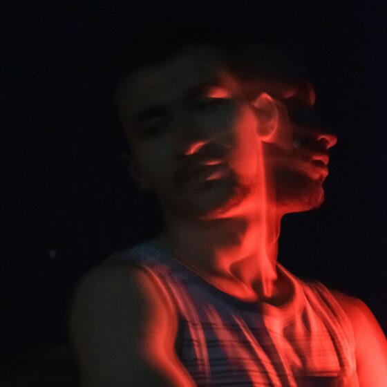 Man with red lighting and double exposure
